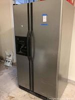 Front exterior view showing stainless steel finish, side-by-side doors, and ice/water dispenser on left door