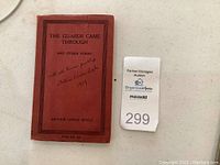 Front cover showing title, inscription and auction tag.