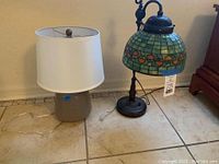 Both lamps displayed side by side on tiled floor showing full bases and shades.