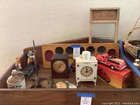 Overview showing both clocks, toy fire truck, mirror piece, board and jar