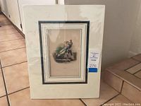 Framed print with matting and protective plastic sleeve showing full view of the image attached to mat with blue and white marbled border.