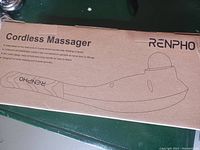 Photo of the boxed Renpho cordless massager showing product illustration and brief product description on the cardboard box.