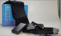 Pair of black heated socks laid out with two rechargeable battery packs, USB charging cable, and original blue packaging box.