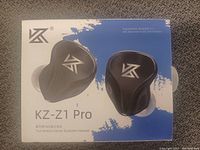 Photo of retail box featuring the KZ-Z1 Pro earbuds, showing product image, brand logo, and details about wireless and audio specs.