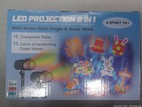 Photo of LED Projection 2 in 1 box showing cartoon-style sea animal and ocean wave themed slides, and 10 colors for ocean wave effect.