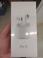 Front view of the sealed box showing image of white earbuds and charging case labeled Pro 4.