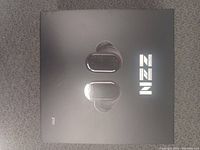 Closed retail box for ZZN ZT01 wireless earbuds showing black earbuds on front and brand logo.