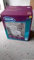 Box packaging of Invacare raised toilet seat model #1391AP showing brand and model details.