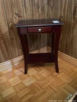 Full view of the wooden side table showing the overall structure and the drawer.