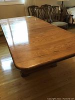Top view of rectangular wood dining table showing smooth polished surface and natural wood grain finish.