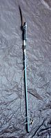 Full extendable pole saw and tree pruner with cord wrapped around pole, shows length and condition of pole