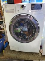 Front view of the Kenmore front load washer showing the door and control panel.