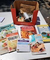 Overview of cookbooks, cookie press box, and recipe cards.