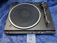 Top view of the Technics SL-DD33 turntable showing rubber platter mat, tonearm, and control buttons on black base.