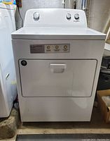 Front view of the white Whirlpool top load gas dryer showing control panel and exterior condition.