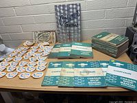 Full view of the Corvair manuals, patches and signs on a table.