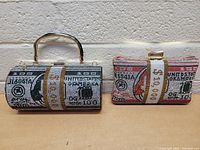 Frontal view of two beaded money purse clutches designed as rolled US dollar bills, displaying detailed beadwork and gold-tone hardware.