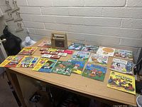 Overview of entire lot showing tape player, tapes, and books on table