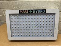 Front view of a Mars Hydro LED grow light showing LED diodes and white frame with brand label
