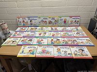 Full view of the 32 books laid out on a table.