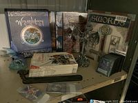 Shelf overview showing books, figurines, incense burner, card packs