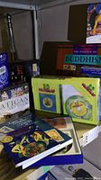 Image showing boxed card decks including 'Worlds of Wonder,' 'The Soul's Journey Lesson Cards,' and 'Vatican Art Deck' along with several books.
