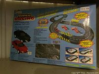 Photo of box back highlights features, track layout, and car images, showing different layout options and accessories.