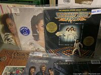 Photo showing Saturday Night Fever soundtrack, Diana Ross, other albums stacked behind in plastic sleeves