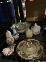 Photo of the china serving items including salad bowl, individual bowls, sugar shaker, sweets tray, covered dish, and keepsake pot, showing floral and decorative patterns