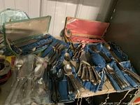 Overall view of silver-plated flatware sets in fabric-lined cases