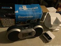 Sirius Sportster SOC1B satellite radio boombox with power cord, shown with original blue box and styrofoam inserts. Missing antenna and activation required. Untested condition.