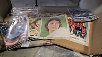 Photo shows a group of vintage magazines and newspapers including a Radio Guide, Rolling Stone magazine (1977), Skyways magazine (1943), London Free Press newspaper (1958), and other newspaper clippings.