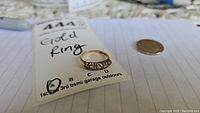 Ring and reference coin on lot card showing overall view and scale