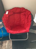 Full view of the papasan chair showing metal frame and red cushioned seat.
