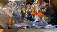 Close-up of multiple action figures in plastic bags showing the full range of different characters and colors.