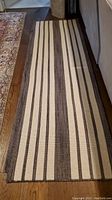 Top view of one striped runner on wood floor, showing full length and pattern.