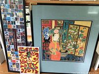 Framed Wu Chi Yong print with blue mat and gold tone frame shown with two other laminated posters: one computer museum art and one Jane Fonda Barbarella poster