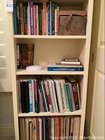 Shelf showing additional health, lactation, and educational books with stacked small books