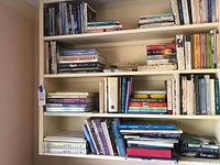 Multiple shelves showing assorted hardcovers and paperbacks