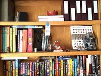 Shelf with books, decorative items and vintage Hot Wheels motorcycle visible