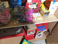 Shelf overview with boxes of Lenox china, Ziploc bags, napkins, butterfly decor