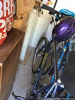 Full view of the Specialized Hard Rock bicycle showing frame, handlebars, and purple helmet placed on bike