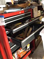 Red Husky rolling toolbox with drawers open showing assorted contents