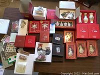Overview of red Lenox boxes, loose ornaments and black Dansk box