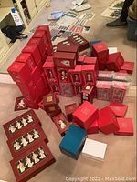 Wide view of numerous red Lenox boxes on carpet