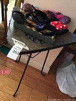 Full view of the metal table with tray and Disney headbands on top showcasing size and overall condition.