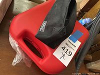 Red hard plastic storage case with handle, black zippered pouch with Wahl logo on top