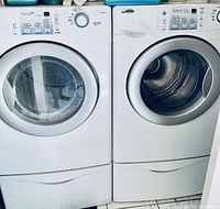 Pair of front-loading washer (left) and dryer (right) in white finish
