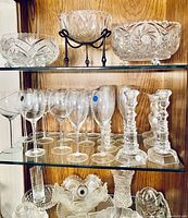 Three cut glass bowls on upper shelf