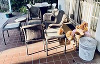 Patio furniture and baskets arranged on tiled patio showing love seat, chairs, side tables, coffee table, and many baskets.